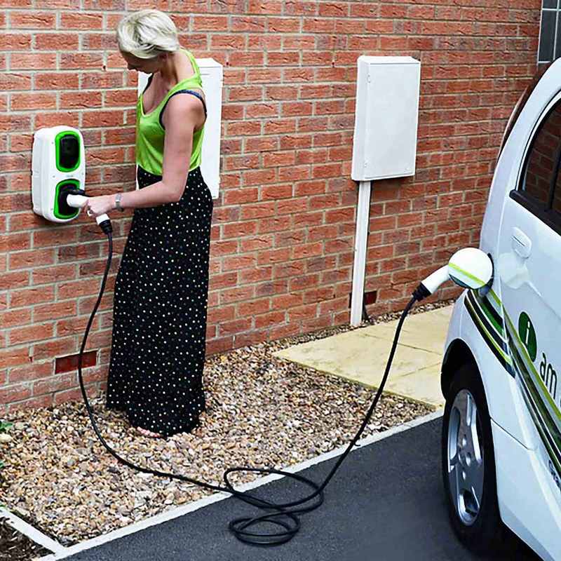 Women charging her EV using a workplace charging station